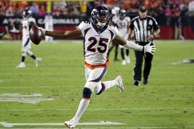 FILE- In this Oct. 18, 2018, file Denver Broncos cornerback Chris Harris Jr. (25) celebrates his interception for a touchdown against the Arizona Cardinals during the first half of an NFL football game in Glendale, Ariz. With Denver out of playoff contention and facing a slew of injuries at the position, the Broncos placed star cornerback Chris Harris Jr. on injured reserve and signed free agent Craig Mager, who was released by the Chargers earlier this season. Harris sustained a chip fracture in his lower right leg two weeks ago.  (AP Photo/Rick Scuteri, File)