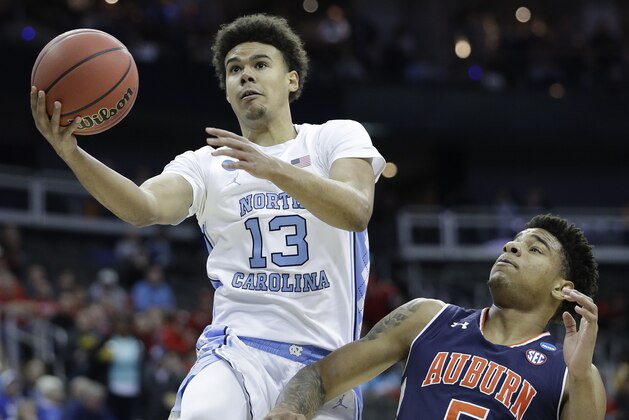 North Carolina's Cameron Johnson (13) heads to the basket past Auburn's Chuma Okeke (5) during the first half of a men's NCAA tournament college basketball Midwest Regional semifinal game Friday, March 29, 2019, in Kansas City, Mo. (AP Photo/Charlie Riedel)