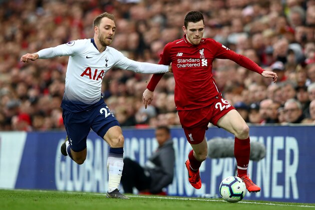 LIVERPOOL, ENGLAND - MARCH 31:  Christian Eriksen of Tottenham Hotspur tackles Andrew Robertson of Liverpool  during the Premier League match between Liverpool FC and Tottenham Hotspur at Anfield on March 31, 2019 in Liverpool, United Kingdom. (Photo by Clive Brunskill/Getty Images)