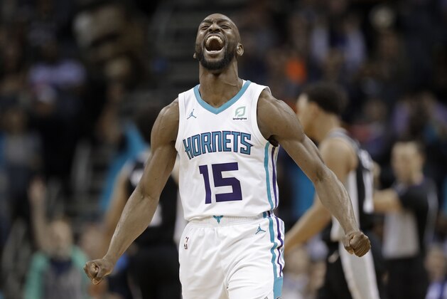 Charlotte Hornets' Kemba Walker (15) reacts after making a basket against the San Antonio Spurs during the second half of an NBA basketball game in Charlotte, N.C., Tuesday, March 26, 2019. (AP Photo/Chuck Burton)