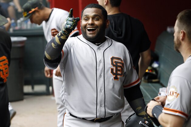 San Francisco Giants' Pablo Sandoval celebrates in the dugout after hitting a pinch-hit home run against the Arizona Diamondbacks during the 10th inning of a baseball game, Sunday, May 19, 2019, in Phoenix. (AP Photo/Ralph Freso)