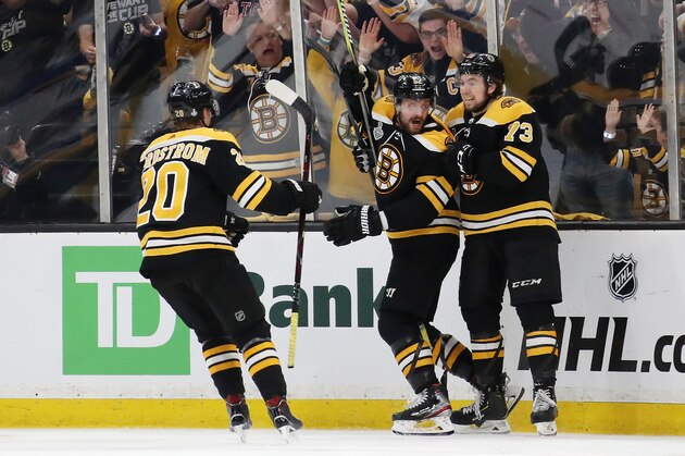 BOSTON, MASSACHUSETTS - MAY 27:  Sean Kuraly #52 of the Boston Bruins is congratulated by his teammates Joakim Nordstrom #20 and Charlie McAvoy #73 after scoring a third period goal against the St. Louis Blues in Game One of the 2019 NHL Stanley Cup Final at TD Garden on May 27, 2019 in Boston, Massachusetts. (Photo by Bruce Bennett/Getty Images)