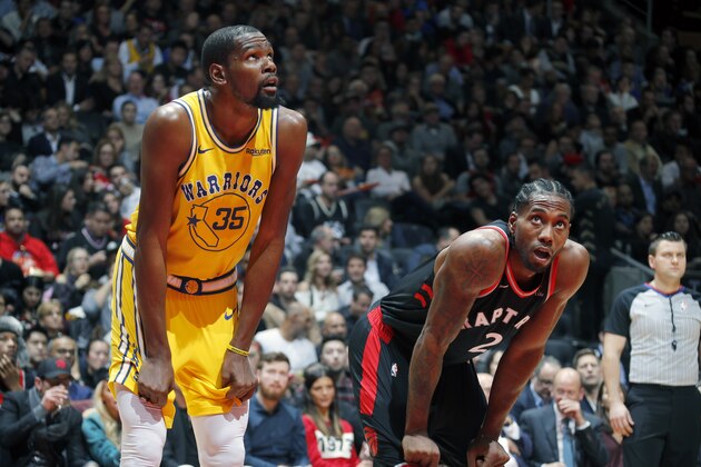 TORONTO, CANADA - NOVEMBER 29: Kevin Durant #35 of the Golden State Warriors and Kawhi Leonard #2 of the Toronto Raptors look on during the game on November 29, 2018 at Scotiabank Arena in Toronto, Ontario, Canada. NOTE TO USER: User expressly acknowledges and agrees that, by downloading and/or using this photograph, user is consenting to the terms and conditions of the Getty Images License Agreement. Mandatory Copyright Notice: Copyright 2018 NBAE (Photo by Mark Blinch/NBAE via Getty Images)