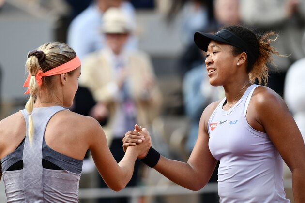 Japan's Naomi Osaka (R) and Slovakia's Anna Karolina Schmiedlova (L) shake hands at the end of their women's singles first round match on day three of The Roland Garros 2019 French Open tennis tournament in Paris on May 28, 2019. (Photo by Philippe LOPEZ / AFP)        (Photo credit should read PHILIPPE LOPEZ/AFP/Getty Images)