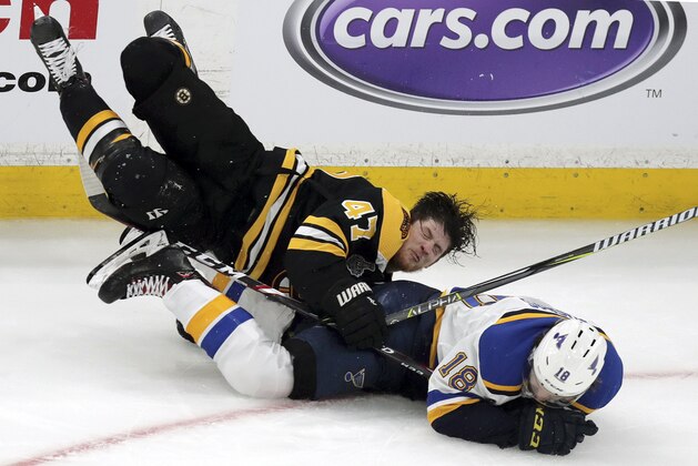Boston Bruins' Torey Krug (47) and St. Louis Blues' Robert Thomas (18) crash to the ice during the third period in Game 1 of the NHL hockey Stanley Cup Final, Monday, May 27, 2019, in Boston. (AP Photo/Charles Krupa)
