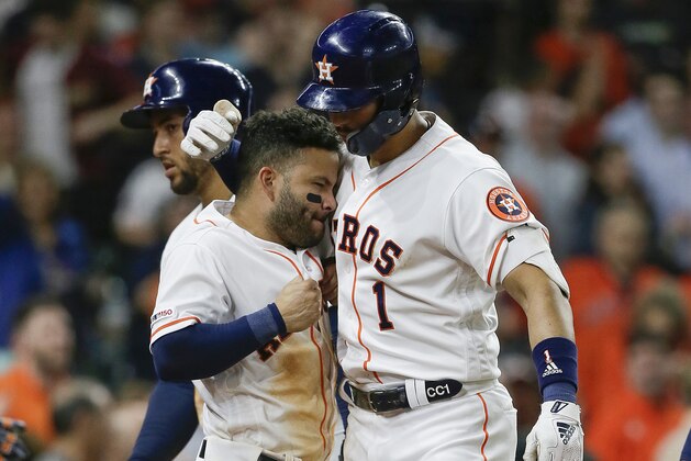 HOUSTON, TEXAS - APRIL 22: Carlos Correa #1 of the Houston Astros receives congratulations from Jose Altuve #27 after hitting a three run home run in the seventh inning against the Minnesota Twins at Minute Maid Park on April 22, 2019 in Houston, Texas. (Photo by Bob Levey/Getty Images)