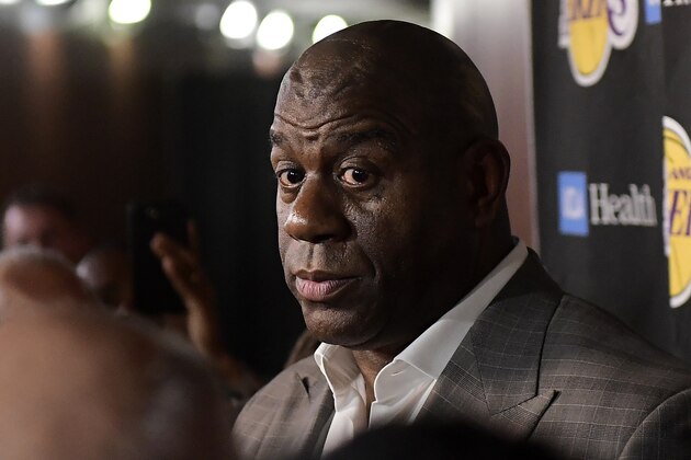 Magic Johnson speaks to reporters prior to an NBA basketball game between the Los Angeles Lakers and the Portland Trail Blazers on Tuesday, April 9, 2019, in Los Angeles. Johnson abruptly quit as the Lakers' president of basketball operations Tuesday night, citing his desire to return to the simpler life he enjoyed as a wealthy businessman and beloved former player before taking charge of the franchise just over two years ago. (AP Photo/Mark J. Terrill)