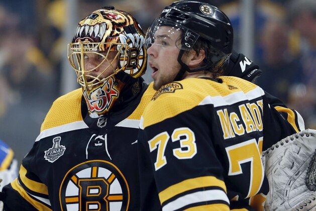 Boston Bruins goaltender Tuukka Rask, left, of Finland, and Charlie McAvoy celebrate victory after Game 1 of the NHL hockey Stanley Cup Final against the St. Louis Blues, Monday, May 27, 2019, in Boston. (AP Photo/Michael Dwyer)