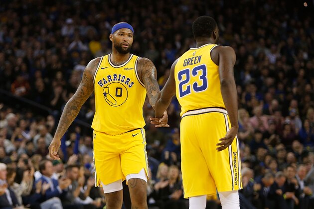 OAKLAND, CA - MARCH 10: DeMarcus Cousins #0 and Draymond Green #23 of the Golden State Warriors high five after a play against the Phoenix Suns at ORACLE Arena on March 10, 2019 in Oakland, California. NOTE TO USER: User expressly acknowledges and agrees that, by downloading and or using this photograph, User is consenting to the terms and conditions of the Getty Images License Agreement. (Photo by Lachlan Cunningham/Getty Images)