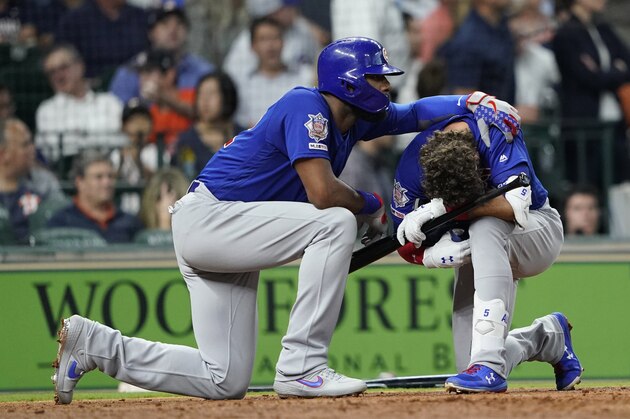 Chicago Cubs' Albert Almora Jr., right, is comforted by Jason Heyward after hitting a foul ball into the stands during the fourth inning of a baseball game against the Houston Astros Wednesday, May 29, 2019, in Houston. (AP Photo/David J. Phillip)
