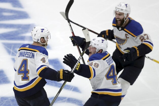CORRECTS SOURCE AND PHOTOGRAPHER'S NAME - St. Louis Blues' Carl Gunnarsson (4), of Sweden, is congratulated by Ivan Barbashev (49), of Russia and Alex Pietrangelo, right, after he scored the winning goal against the Boston Bruins during the first overtime period in Game 2 of the NHL hockey Stanley Cup Final, Wednesday, May 29, 2019, in Boston. (AP Photo/Charles Krupa)