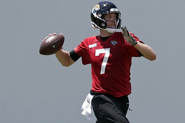 Jacksonville Jaguars quarterback Nick Foles looks for a receiver during an NFL football practice, Tuesday, May 21, 2019, in Jacksonville, Fla. (AP Photo/John Raoux)