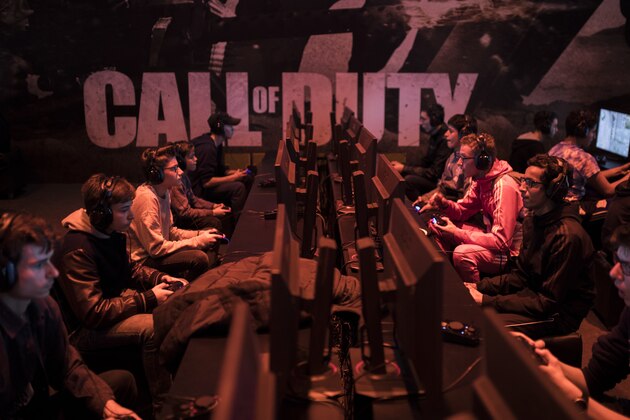 Visitors play Call of Duty WWII video game at the Paris Games Week in Paris, Friday, Nov. 3, 2017. The Paris Games Week, or more commonly called