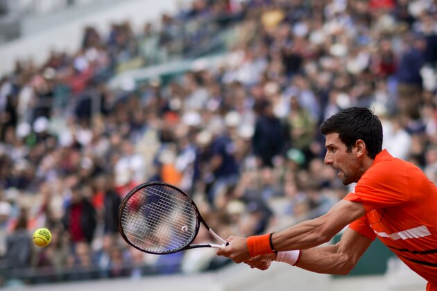 Serbia's Novak Djokovic plays a backhand return to Switzerland's Henri Laaksonen during their men's singles second round match on day five of The Roland Garros 2019 French Open tennis tournament in Paris on May 30, 2019. (Photo by Kenzo TRIBOUILLARD / AFP)        (Photo credit should read KENZO TRIBOUILLARD/AFP/Getty Images)