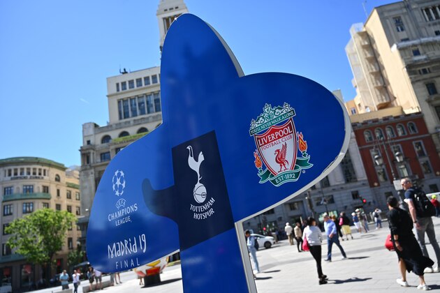 People walk past a sign for the UEFA Champions League final football match between Liverpool and Tottenham Hotspur in Madrid on May 29, 2019. (Photo by GABRIEL BOUYS / AFP)        (Photo credit should read GABRIEL BOUYS/AFP/Getty Images)