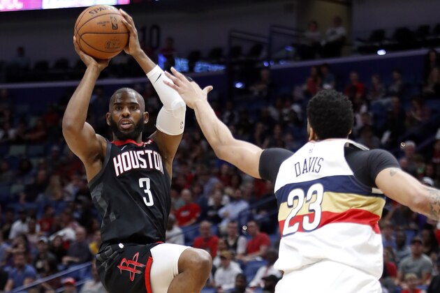 Houston Rockets guard Chris Paul (3) passes the ball in front of New Orleans Pelicans forward Anthony Davis (23) during the first half of an NBA basketball game in New Orleans, Sunday, March 24, 2019. (AP Photo/Tyler Kaufman)