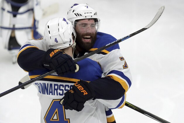 CORRECTS SOURCE AND PHOTOGRAPHER'S NAME - St. Louis Blues' Carl Gunnarsson (4), of Sweden, is congratulated by Pat Maroon, rear, after he scored the winning goal against the Boston Bruins during the first overtime period in Game 2 of the NHL hockey Stanley Cup Final, Wednesday, May 29, 2019, in Boston. (AP Photo/Charles Krupa)