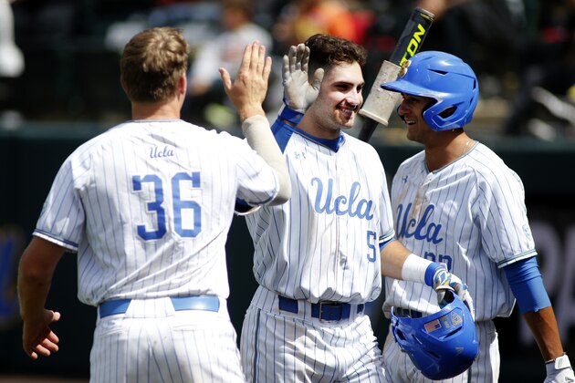 LOS ANGELES, CALIFORNIA - MAY 19:   Garrett Mitchell #5 of UCLA, Jake Pries #36 of UCLA and Chase Strumpf #33 of UCLA high-five following Mitchell's home run during a baseball game against University of Washington at Jackie Robinson Stadium on May 19, 2019 in Los Angeles, California. (Photo by Katharine Lotze/Getty Images)