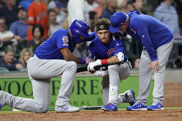 Chicago Cubs' Albert Almora Jr., center, takes a knee as Jason Heyward, left, and manager Joe Maddon, right, talk to him after hitting a foul ball into the stands during the fourth inning of a baseball game against the Houston Astros Wednesday, May 29, 2019, in Houston. (AP Photo/David J. Phillip)