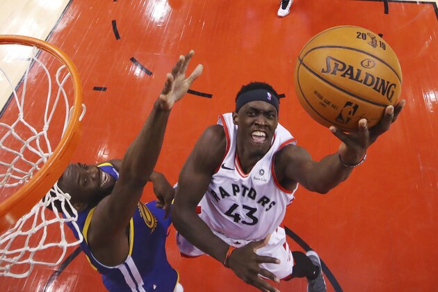 Toronto Raptors' Kawhi Leonard (2) drives to the basket as Golden State Warriors' Andre Iguaodala (9) defends during Game 1 of basketball's NBA Finals in Toronto on Thursday, May 30, 2019. (Gregory Shamus/Pool Photo via AP)