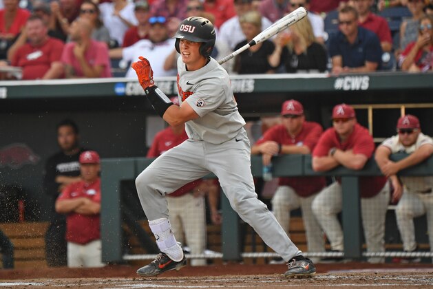 Omaha, NE - JUNE 28:  Catcher Adley Rutschman #35 of the Oregon State Beavers singes in a run in the first inning against the Arkansas Razorbacks during game three of the College World Series Championship Series on June 28, 2018 at TD Ameritrade Park in Omaha, Nebraska.  (Photo by Peter Aiken/Getty Images)