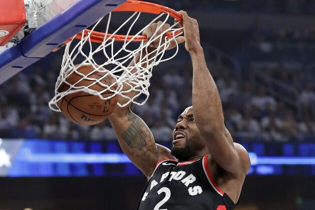 Toronto Raptors' Kawhi Leonard makes an uncontested dunk against the Orlando Magic during the first half in Game 3 of a first-round NBA basketball playoff series, Friday, April 19, 2019, in Orlando, Fla. (AP Photo/John Raoux)