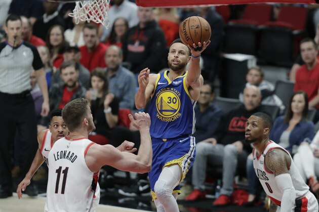 Golden State Warriors guard Stephen Curry (30) puts up a shot against Portland Trail Blazers forward Meyers Leonard (11) during the second half of Game 4 of the NBA basketball playoffs Western Conference finals, Monday, May 20, 2019, in Portland, Ore. The Warriors won 119-117 in overtime. (AP Photo/Ted S. Warren)
