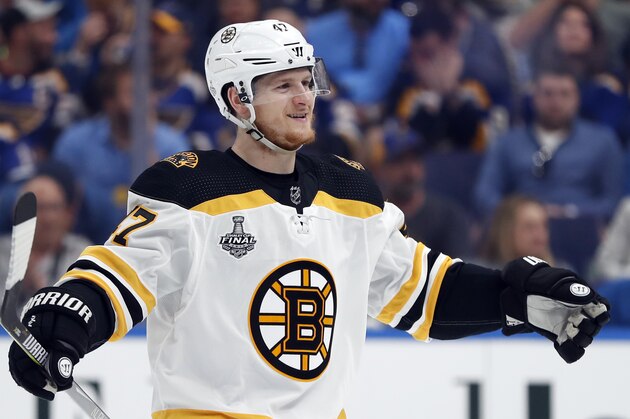 Boston Bruins defenseman Torey Krug celebrates a teammate's goal against the St. Louis Blues during the first period of Game 3 of the NHL hockey Stanley Cup Final Saturday, June 1, 2019, in St. Louis. (AP Photo/Jeff Roberson)