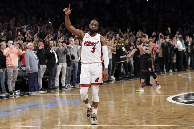 Miami Heat guard Dwyane Wade (3) acknowledges the crowd's cheers after playing in the final NBA basketball game of his career, against the Brooklyn Nets on Wednesday, April 10, 2019, in New York. (AP Photo/Kathy Willens)