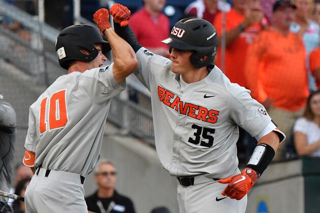 Omaha, NE - JUNE 27:  Catcher Adley Rutschman #35 of the Oregon State Beavers celebrates after hitting a solo home run in the fourth inning against the Arkansas Razorbacks during game two of the College World Series Championship Series on June 27, 2018 at TD Ameritrade Park in Omaha, Nebraska.  (Photo by Peter Aiken/Getty Images)