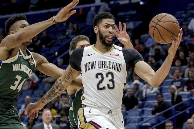 New Orleans Pelicans forward Anthony Davis (23) takes an outlet pass against Milwaukee Bucks forward Giannis Antetokounmpo (34) in the first half of an NBA basketball game in New Orleans, Tuesday, March 12, 2019. (AP Photo/Scott Threlkeld)