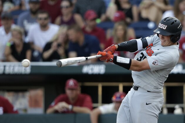 FILE  - In this June 28, 2018, file photo, Oregon State's Adley Rutschman hits an RBI single to score Cadyn Grenier during the third inning of Game 3 against Arkansas in the NCAA College World Series baseball finals, in Omaha, Neb. The Baltimore Orioles lead off the Major League Baseball Draft for the first time in 30 years and Oregon State catcher Adley Rutschman is a heavy favorite to be selected No. 1 on Monday night, June 3, 2019. (AP Photo/Nati Harnik, File)