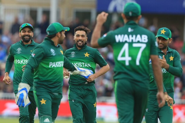 Pakistan's Mohammad Amir (C) celebrates after taking the wicket of England's Jos Buttler during the 2019 Cricket World Cup group stage match between England and Pakistan at Trent Bridge in Nottingham, central England, on June 3, 2019. (Photo by Lindsey PARNABY / AFP) / RESTRICTED TO EDITORIAL USE        (Photo credit should read LINDSEY PARNABY/AFP/Getty Images)