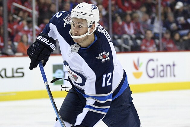 FILE - In this March 10, 2019, file photo, Winnipeg Jets right wing Kevin Hayes (12) shoots the puck during the second period of an NHL hockey game against the Washington Capitals, in Washington. Thirty-two players were involved in 20 deals struck at the NHL trade deadline on Feb. 25. The Winnipeg Jets led the way in completing six trades, including acquiring veteran center Kevin Hayes from the New York Rangers. (AP Photo/Nick Wass, File)