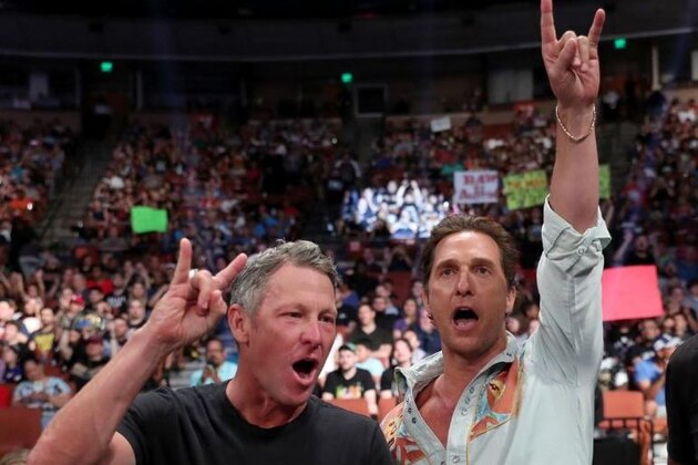 Tour de France winner Lance Armstrong, left, and actor Matthew McConaughey, both Texas natives, celebrate the Texas 41-38 victory over Southern California in the Rose Bowl, the national championship college football game in Pasadena, Calif., Wednesday, Jan. 4, 2006. (AP Photo/Chris Carlson)