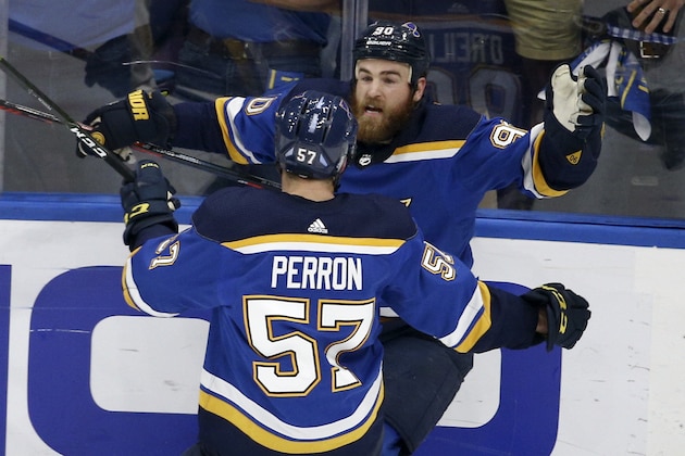 St. Louis Blues center Ryan O'Reilly (90) celebrates with David Perron (57) after O'Reilly scored his second goal of the game during the third period of Game 4 of the NHL hockey Stanley Cup Final against the Boston Bruins Monday, June 3, 2019, in St. Louis. (AP Photo/Scott Kane)