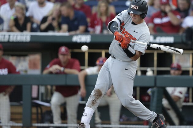 File-This June 28, 2018, file photo shows Oregon State Adley Rutschman hitting an RBI single to score Cadyn Grenier during the third inning of Game 3 against Arkansas in the NCAA College World Series baseball finals, in Omaha, Neb. The Beavers posted some of the best numbers in program history last year, and six of the players from the everyday lineup are gone. They still have Rutschman, the 2018 CWS Most Outstanding Player and possible No. 1 pick in the Major League Baseball draft in June, along with first baseman Zak Taylor and outfielder Preston Jones.(AP Photo/Nati Harnik, File)
