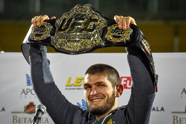 UFC lightweight champion Khabib Nurmagomedov of Russia raises his champions belt upon the arrival in Makhachkala on October 8, 2018. - Nurmagomedov defeated Conor McGregor of Ireland in their UFC lightweight championship bout by way of submission during the UFC 229 event inside T-Mobile Arena on October 6, 2018 in Las Vegas, Nevada. (Photo by Vasily MAXIMOV / AFP)        (Photo credit should read VASILY MAXIMOV/AFP/Getty Images)
