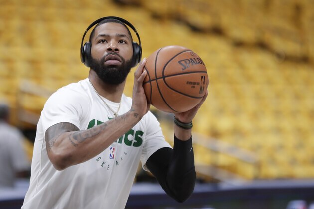 Boston Celtics forward Marcus Morris (13) shoots during warms-ups before Game 4 of an NBA basketball first-round playoff series against the Indiana Pacers in Indianapolis, Sunday, April 21, 2019. (AP Photo/Michael Conroy)