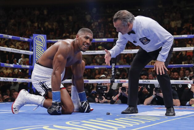 Anthony Joshua waits during the referee's count after he was knocked down during the seventh round of a heavyweight championship boxing match against Andy Ruiz on Saturday, June 1, 2019, in New York. Ruiz won in the seventh round. (AP Photo/Frank Franklin II)