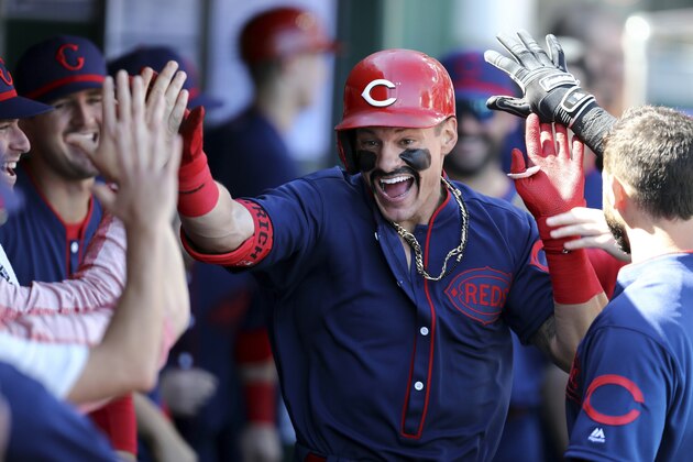 Cincinnati Reds' Derek Dietrich celebrates with teammates after hitting a solo home run in the first inning of a baseball game against the San Francisco Giants, Sunday, May 5, 2019, in Cincinnati. (AP Photo/Aaron Doster)