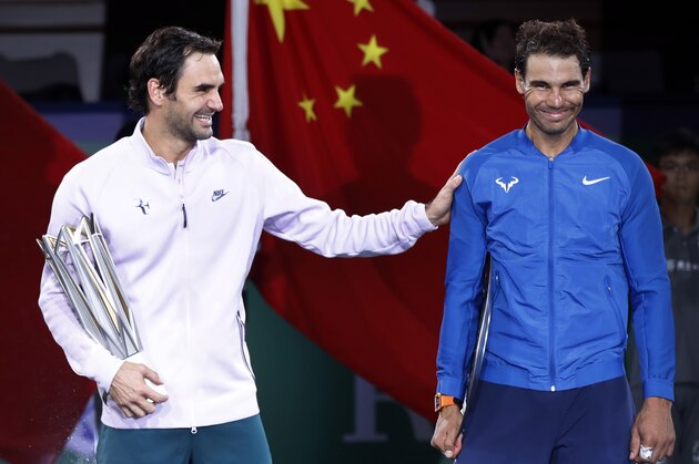 Roger Federer of Switzerland, left, gestures with Spain's Rafael Nadal after winning their men's singles final match in the Shanghai Masters tennis tournament at Qizhong Forest Sports City Tennis Center in Shanghai, China, Sunday, Oct. 15, 2017. (AP Photo/Andy Wong)
