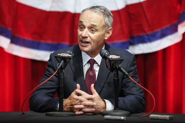 Major League Baseball  Commissioner Rob Manfred speaks to reporters before an opening day baseball game between the Cincinnati Reds and the Pittsburgh Pirates, Thursday, March 28, 2019, in Cincinnati. (AP Photo/John Minchillo)