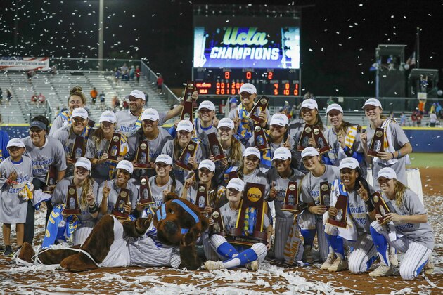 The UCLA team poses for photos after defeating Oklahoma in the NCAA softball Women's College World Series in Oklahoma City, Tuesday, June 4, 2019. UCLA won 5-4 in Game 2, taking both games in the best-of-three series. (AP Photo/Alonzo Adams)