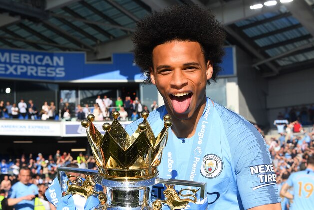 BRIGHTON, ENGLAND - MAY 12: Leroy Sane of Manchester City celebrates with the Premier League Trophy after winning the title during the Premier League match between Brighton & Hove Albion and Manchester City at American Express Community Stadium on May 12, 2019 in Brighton, United Kingdom. (Photo by Michael Regan/Getty Images)
