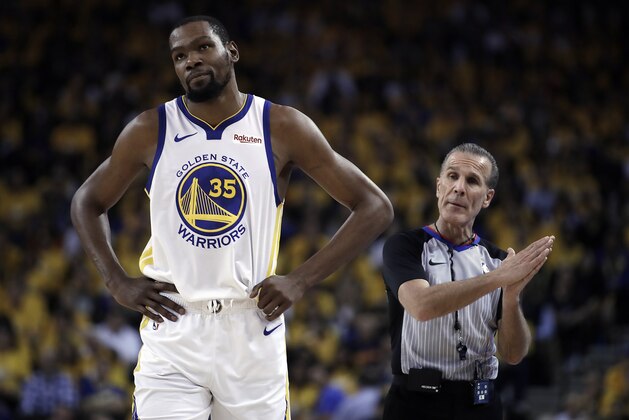 Golden State Warriors' Kevin Durant, left, walks away from referee Ken Mauer during the first half of Game 5 of the team's second-round NBA basketball playoff series against the Houston Rockets on  Wednesday, May 8, 2019, in Oakland, Calif. (AP Photo/Ben Margot)