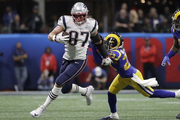 FILE - In this Feb. 3, 2019, file photo, New England Patriots' Rob Gronkowski (87) runs against Los Angeles Rams' Nickell Robey-Coleman (23) during the first half of the NFL Super Bowl 53 football game in Atlanta. Gronkowski says he is retiring from the NFL after nine seasons. Gronkowski announced his decision via a post on Instagram Sunday, March 24, 2019, saying that a few months shy of this 30th birthday “its time to move forward and move forward with a big smile.” (AP Photo/Jeff Roberson, File)