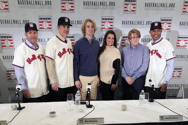 Baseball Hall of Fame inductees Edgar Martinez, left, Mike Mussina, and Mariano Rivera, right, pose for photographs with, Braden Halladay, third from left, Brandy Halladay, center, and Ryan Halladay, after a news conference Wednesday, Jan. 23, 2019, in New York. (AP Photo/Frank Franklin II)