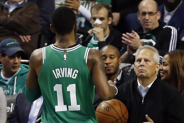 Boston Celtics general manager Danny Ainge tosses the ball, which went out of bounds, to Kyrie Irving during the first quarter of an NBA basketball game against the Los Angeles Lakers in Boston Wednesday, Nov. 8, 2017. (AP Photo/Winslow Townson)