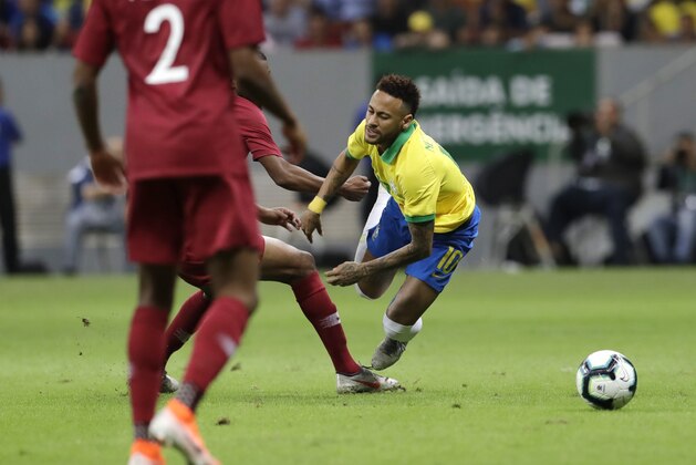 Brazil's Neymar, right, gestures after being fouled during a friendly soccer match against Qatar at the Estadio Nacional in Brasilia, Brazil, Wednesday, June 5, 2019. Brazil and Qatar are preparing for the Copa America which runs from June 14 until July 7 in Brazil. (AP Photo/Eraldo Peres)